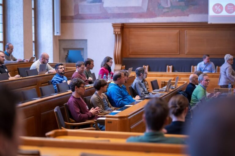 Participants with laptops in the council benches