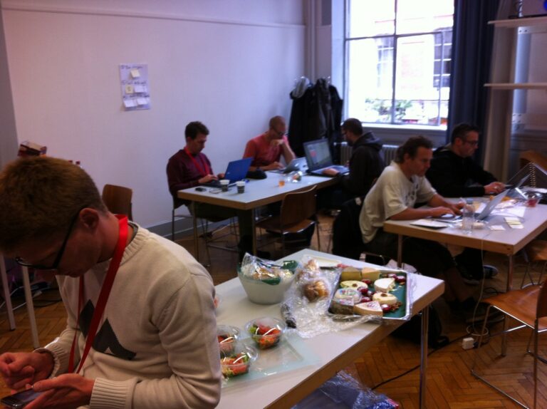 Teams at tables with laptops