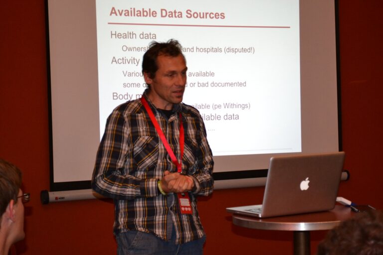Speaker in front of a slide «Available Data Sources»