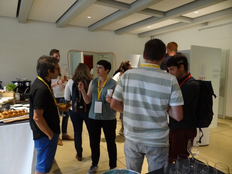 Participants with badges talking in the foyer