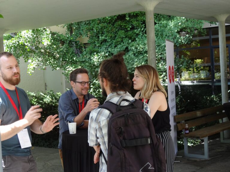 Four people talking outdoors