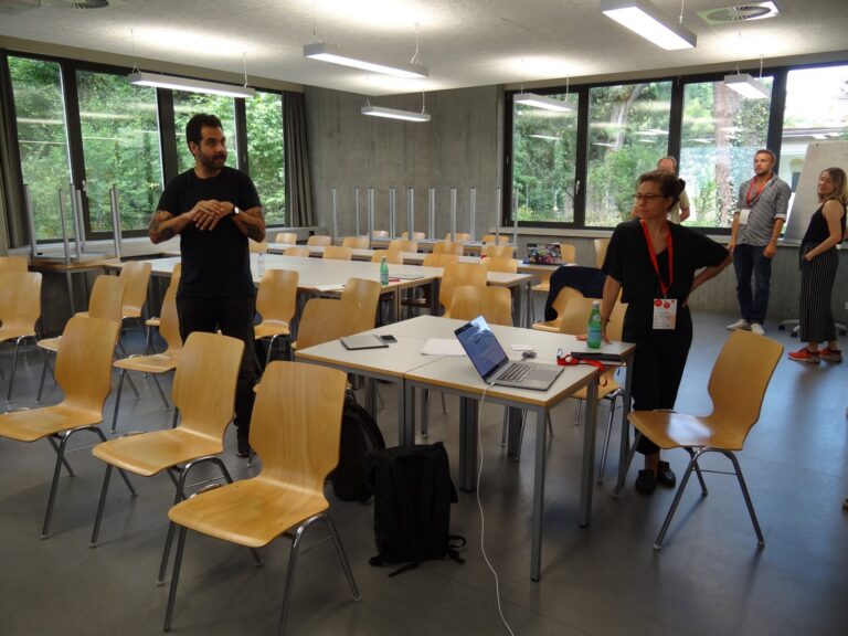 Facilitator and participants in a seminar room