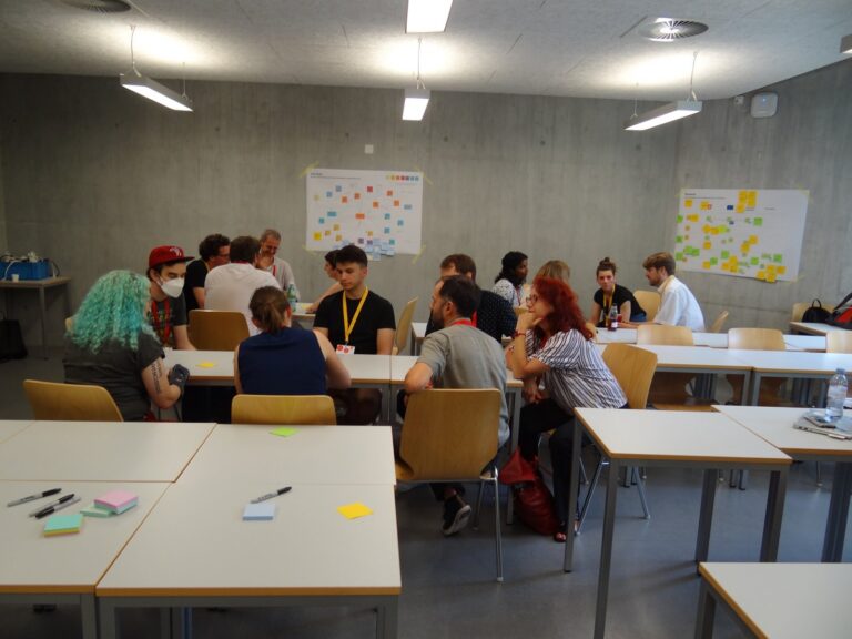Small groups at tables in a seminar room