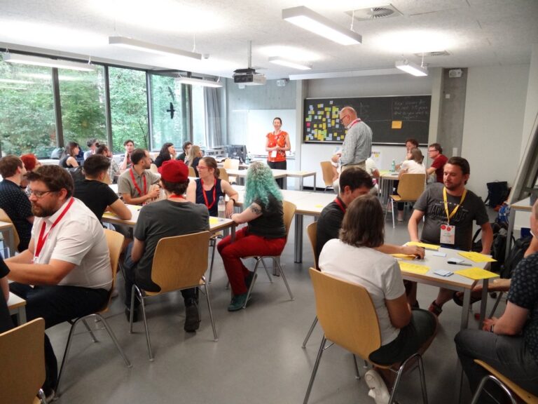 Full seminar room with groups at tables