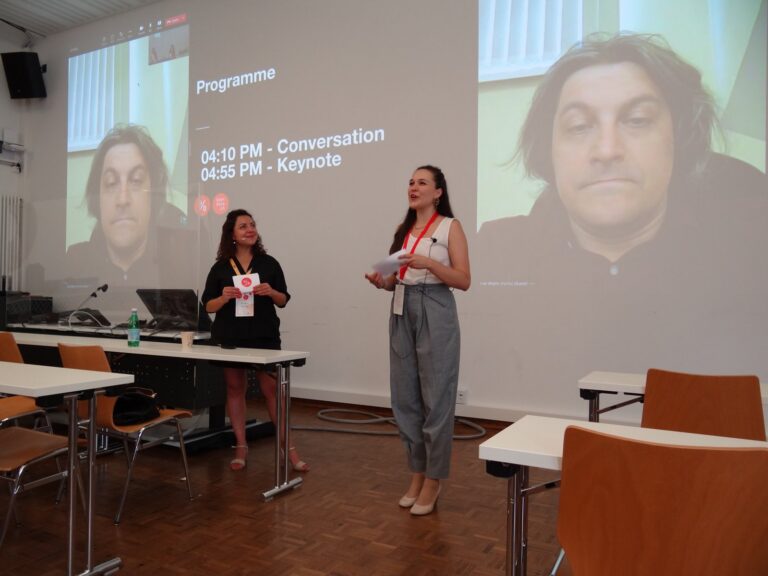 Two hosts at the front, Ivan Begtin on screen via video