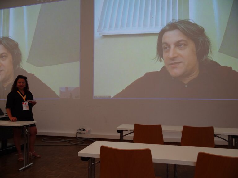 Renata Ávila in front of the screen showing Ivan Begtin